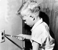 kid putting knife in electrical outlet